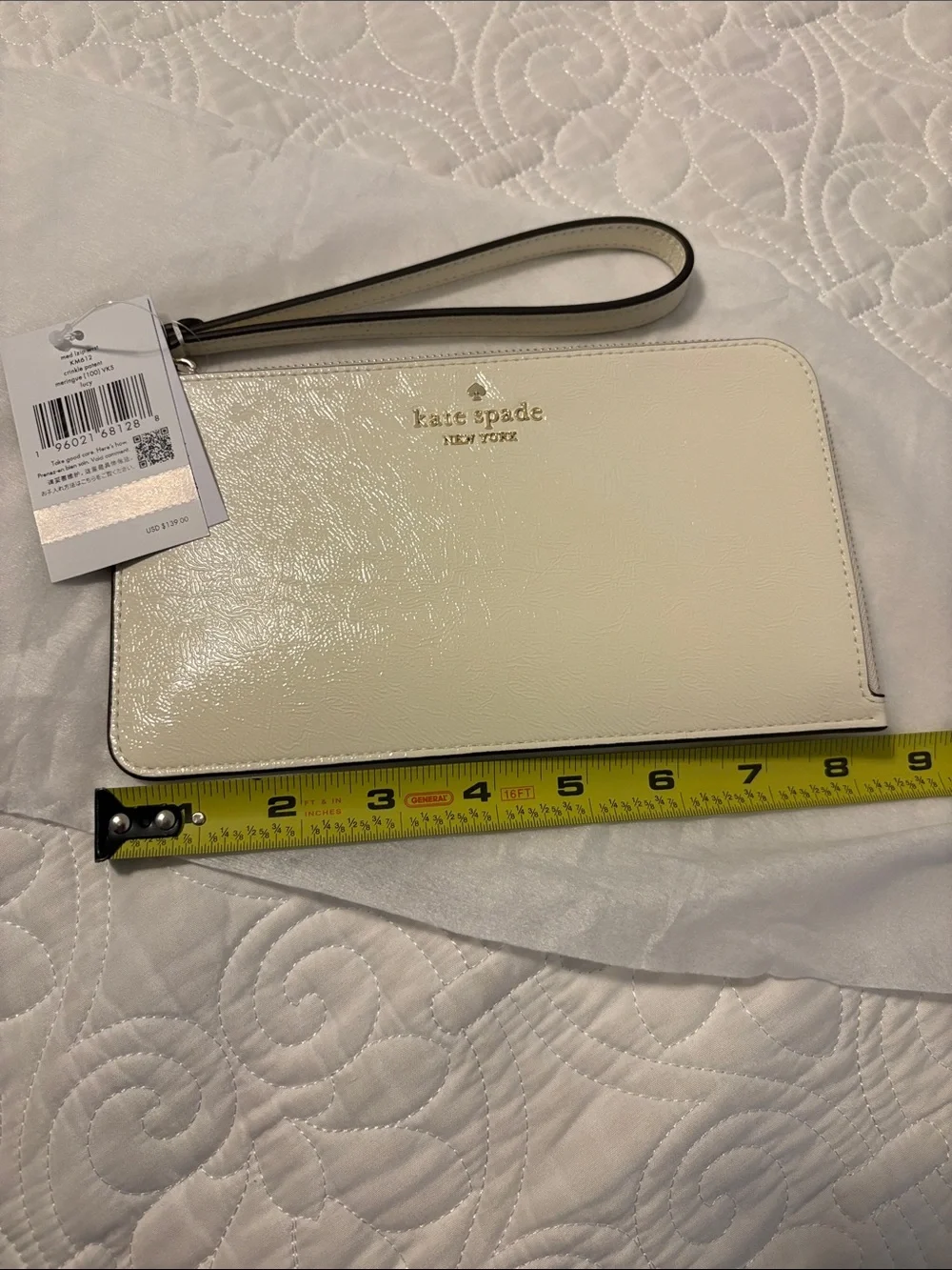 kate spade cream patent leather wristlet with gold logo